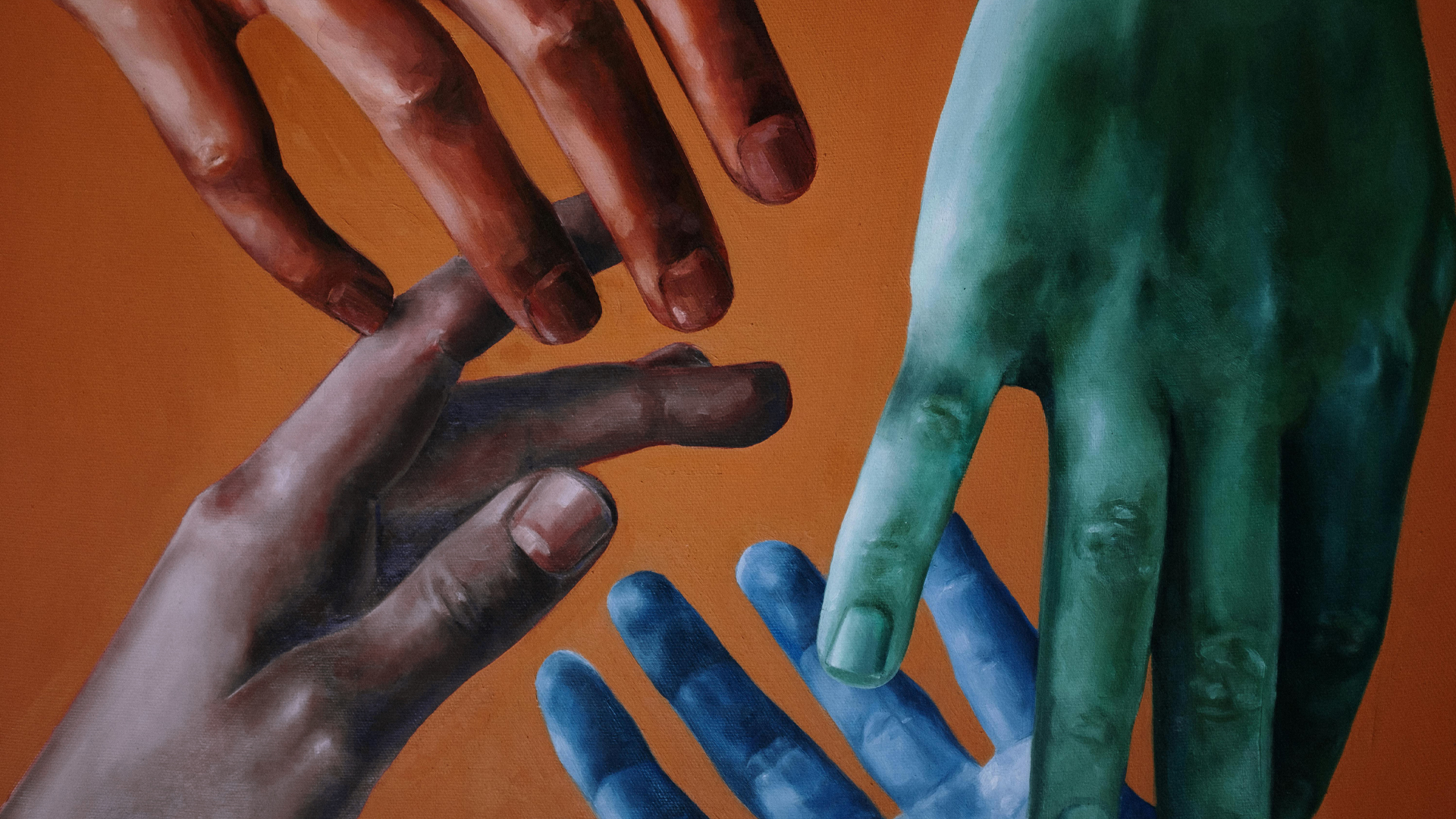 four hands pointing to the centre